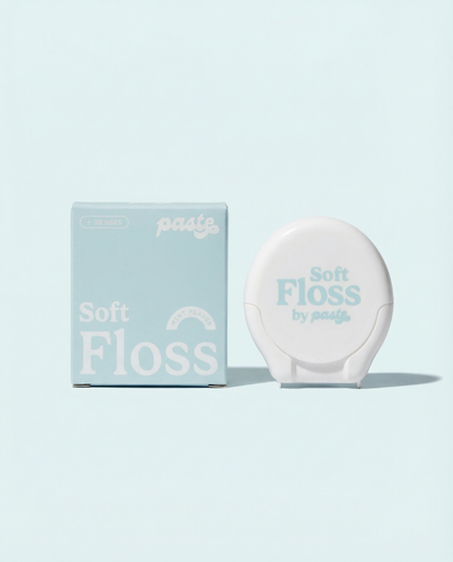 Light blue box and white compact for Paste Soft Floss in Mint flavor (30 uses) displayed side by side on a pale blue background.